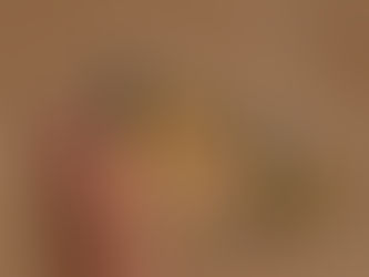 Close‑up of an orange and black monarch‑style butterfly gently resting on a person’s fingertip, symbolizing calm, trust, and personal transformation.