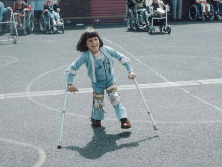 little girl walking with assistive device