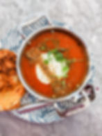 tomato sauce in bowl bread on white plate