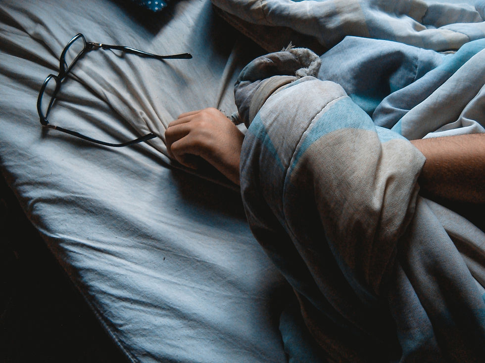 An individual in peaceful slumber, highlighting the importance of quality sleep for cortisol management and overall well-being.