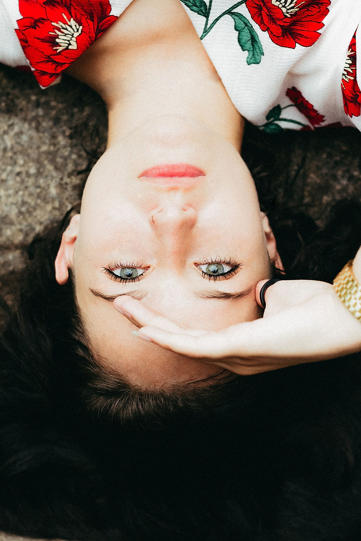 upside down shot of a young woman with a pensive expression on her face