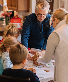 An older man and woman around a kitchen table with 3 younger children. Grandparents have certain rights in Pennsylvania. Ruppert Law Firm helps grandparents in pittsburgh, irwin, Allegheny, westmoreland, butler, cranberry twp, and monroeville get visitation and custody of their grandchildren.