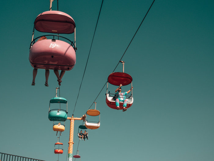 Colourful cable cars against a teal sky