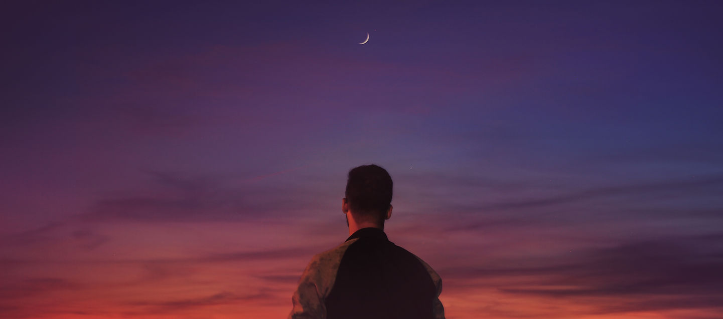 Man looking up at the stars, symbolising searching for meaning.