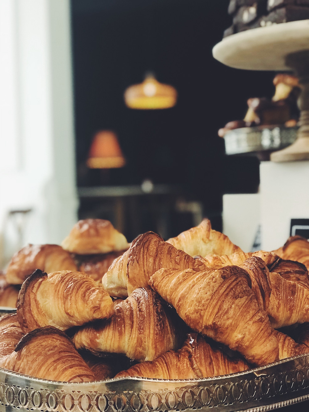 A stack of croissants in a bakery tray