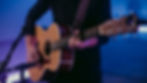 a guitar player using a capo