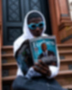 A man reading about a man on the cover of forbes magazine - luck or hardwork?
