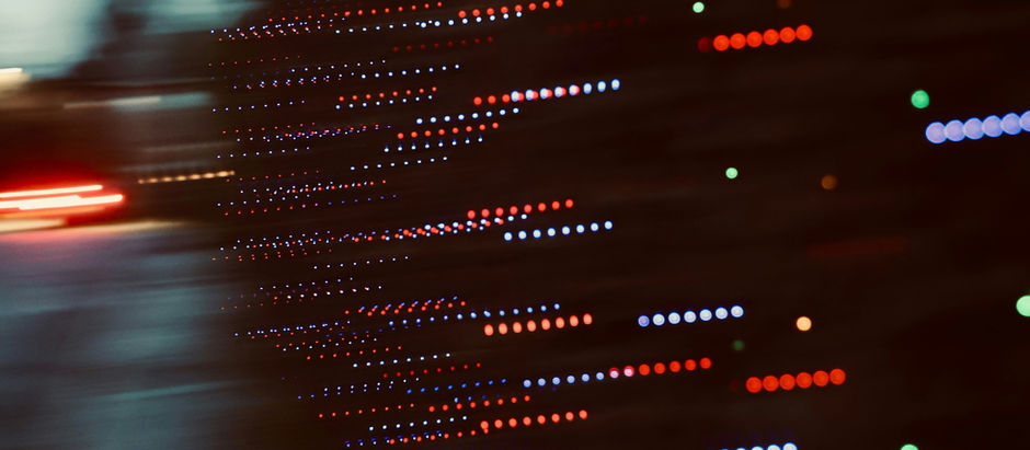 Blurred street scene with colorful lights streaking in lines, creating a dynamic and vibrant visual effect. Dark and moody ambiance.