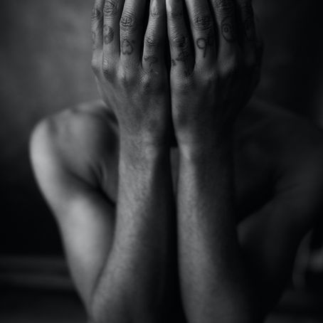 B/w of man with head in hands
