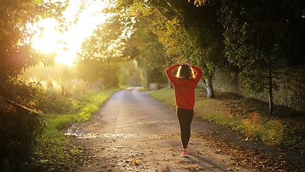 a picture of a women walking down a path