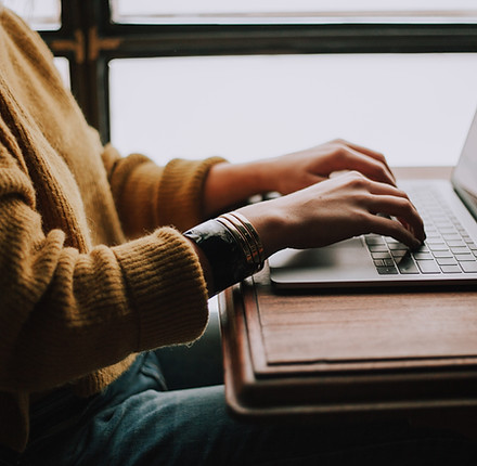 Person using a laptop with MasRefund website for tax filing information