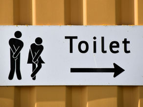 Public "Toilet" Sign with male and female illustrations  indicating the need to pee right away.