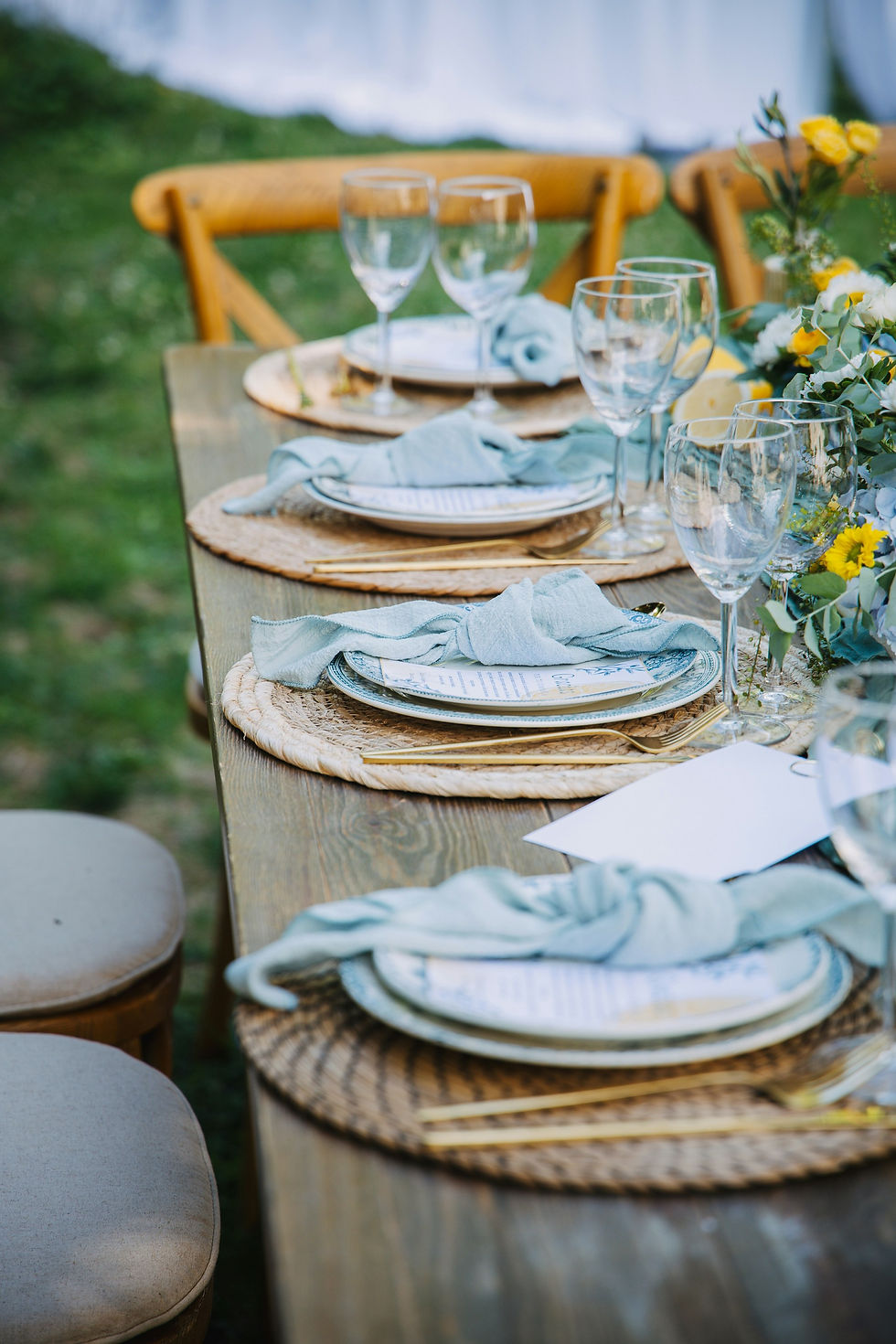 Eye-level view of a beautifully arranged dining table with casual tableware and fresh flowers