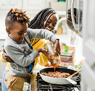 child helping mother cook