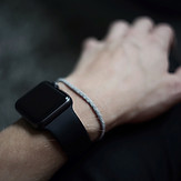 Hand wearing a smart watch and bracelet