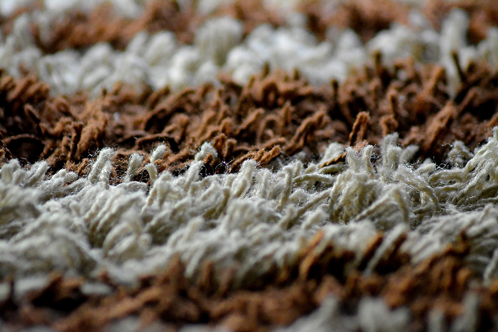 Brown and white colored carpeting.