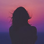 Silhouette of a woman with a sunset behind