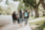 College students walking across a quiet university campus during the first weeks of college, illustrating homesickness and the transition to independence.