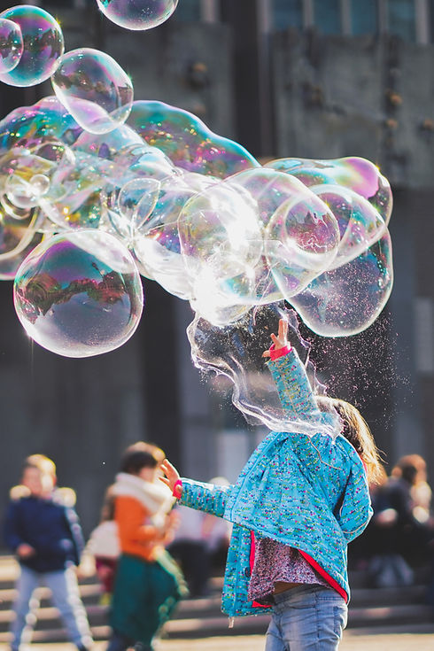 Girl playing with bubbles