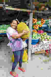 woman holding large jackfruit