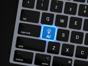 Close-up of a computer keyboard with a glowing blue “AI” key, symbolising how generative engines now sit at the centre of PR strategy, shaping how brand authority, trust, and expertise are interpreted and communicated.