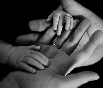 Mum, Dad and baby holding hands