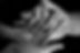 hands layed unto of each other with a small baby-sized hand at the top