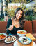 A smiling woman enjoying a mindful meal