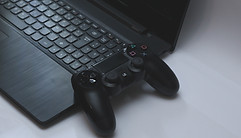 Image of computer with game controller by Nassim Allia