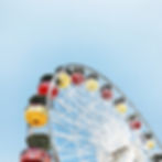A ferris wheel with colorful seats