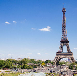 The Eiffel Tower against a blue summer sky