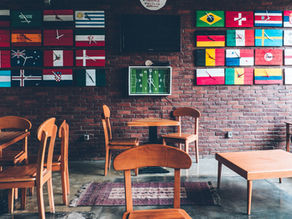 Classroom desk and chair with flags on the wall.