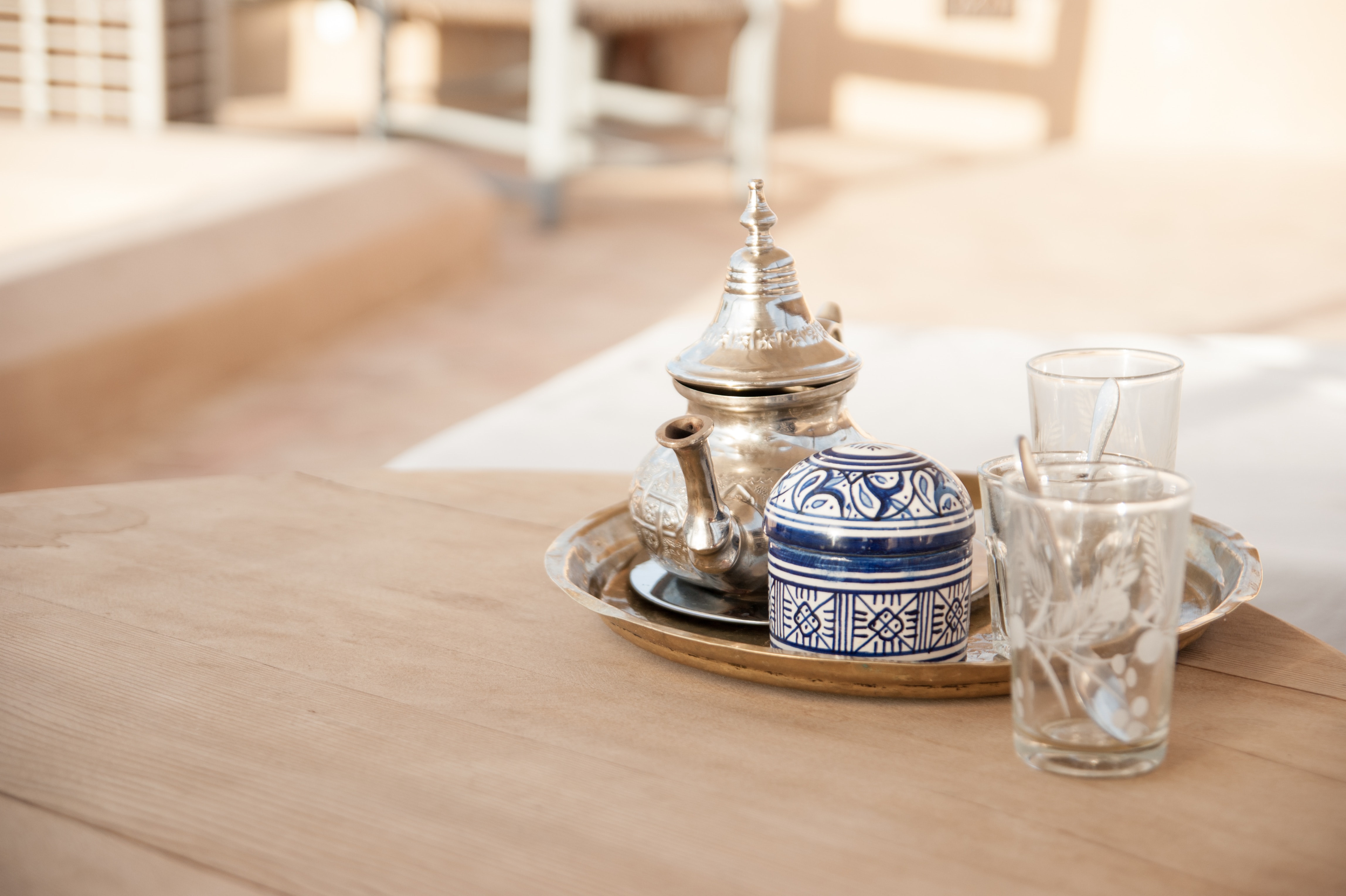Close-up view of a traditional Moroccan tea set on a wooden table