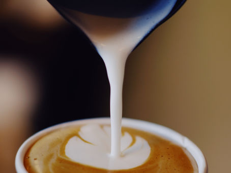 creamer pouring into coffee