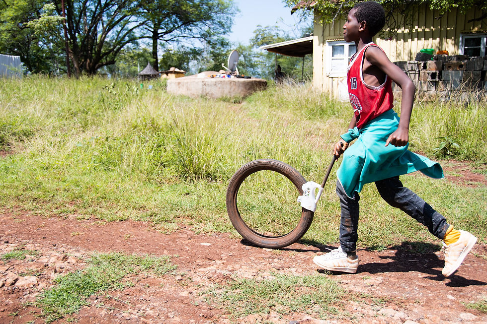 Person walking a bicycle along a dirt path in a rural setting, photographed by Taylor Flowe