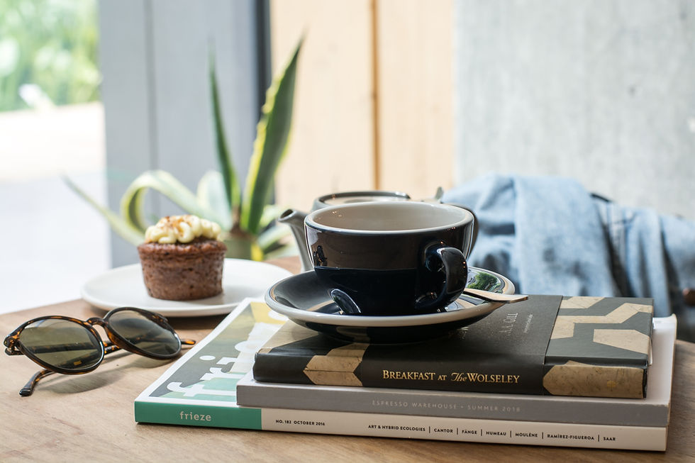 Minimal desk with coffee and laptop representing financial clarity, calm routines, and aligned living