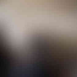 Interior of a minimalist clothing shop with sustainable fashion items displayed on simple, modern racks. The shop features clean lines and neutral tones, emphasizing eco-friendly and ethical clothing choices.