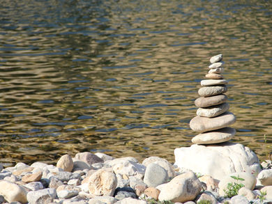 Stacked rocks in front of water
