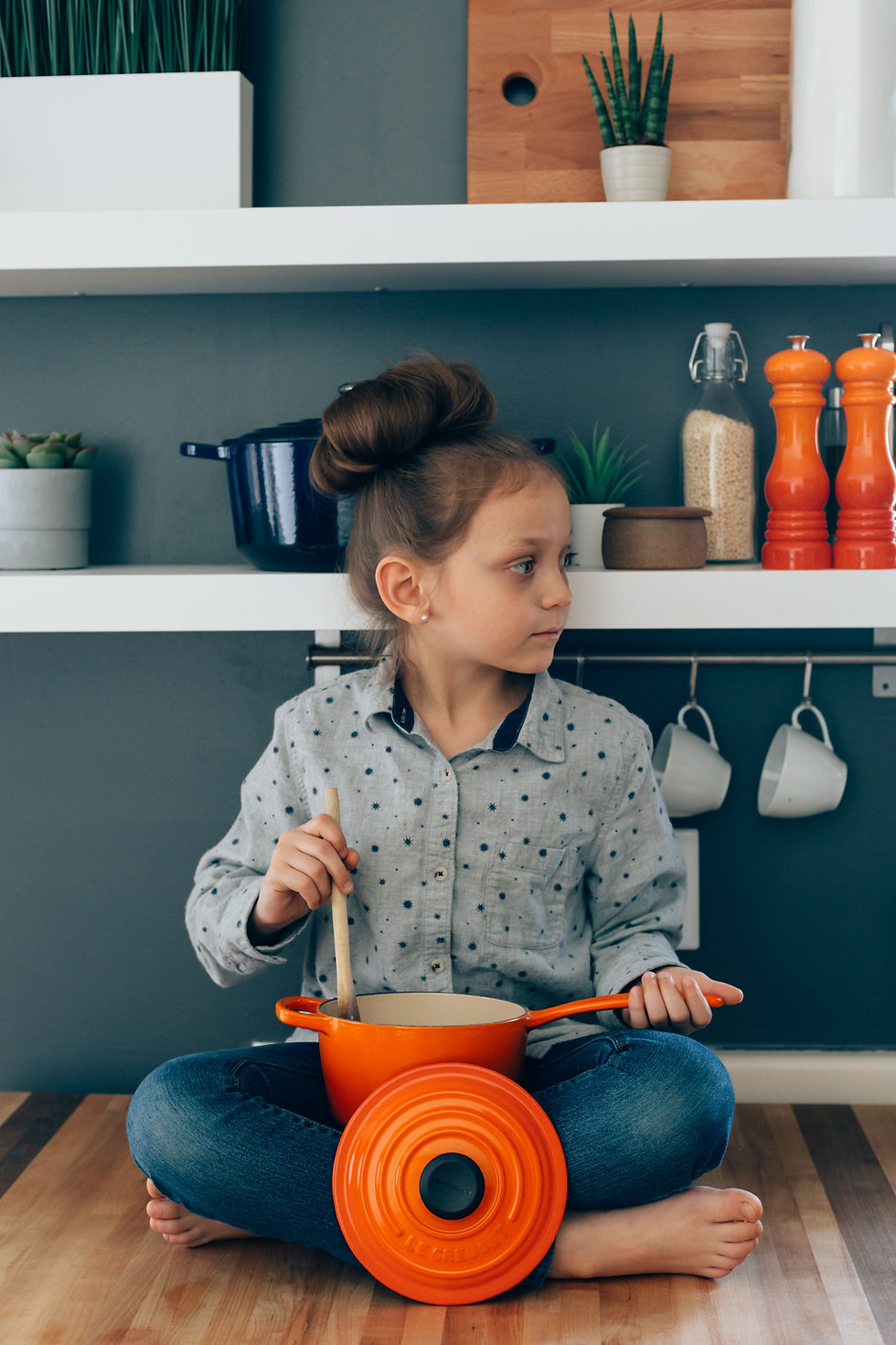 over stimulated child - little girl playing at stirring a pot