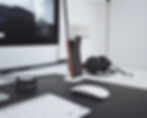 Desk with computer, headphones and phone