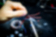 A driver's identification card placed next to a modern key fob used for vehicle access and ignition. The ID card shows the driver's details, while the key fob features buttons for remote control functions.