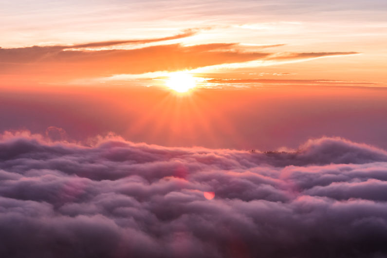 Orange sun above clouds