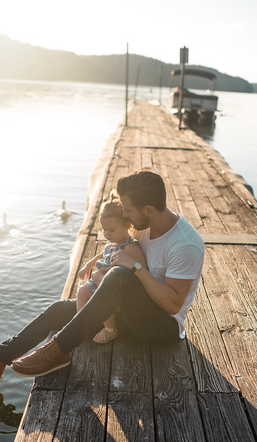 Father and daughter sitting on a warf - Life Insurance Tomball TX - Protecting your family in the event of your absence.
