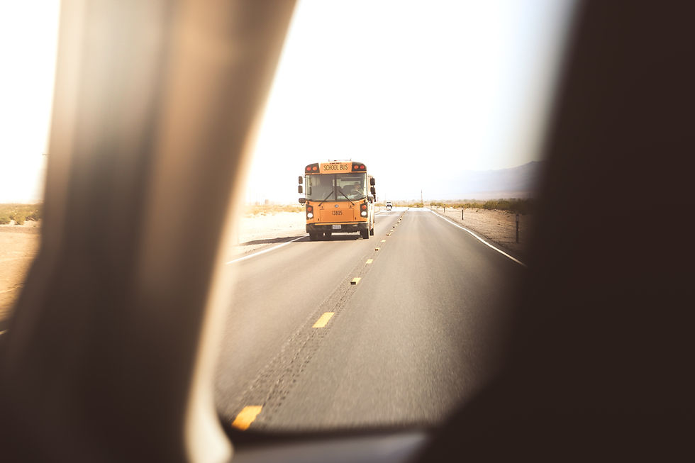 Grieving teenager driving near a school bus.