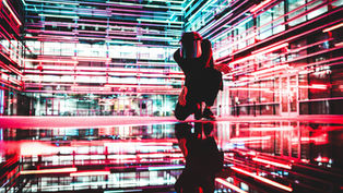 Kneeling in colourful electric landscape