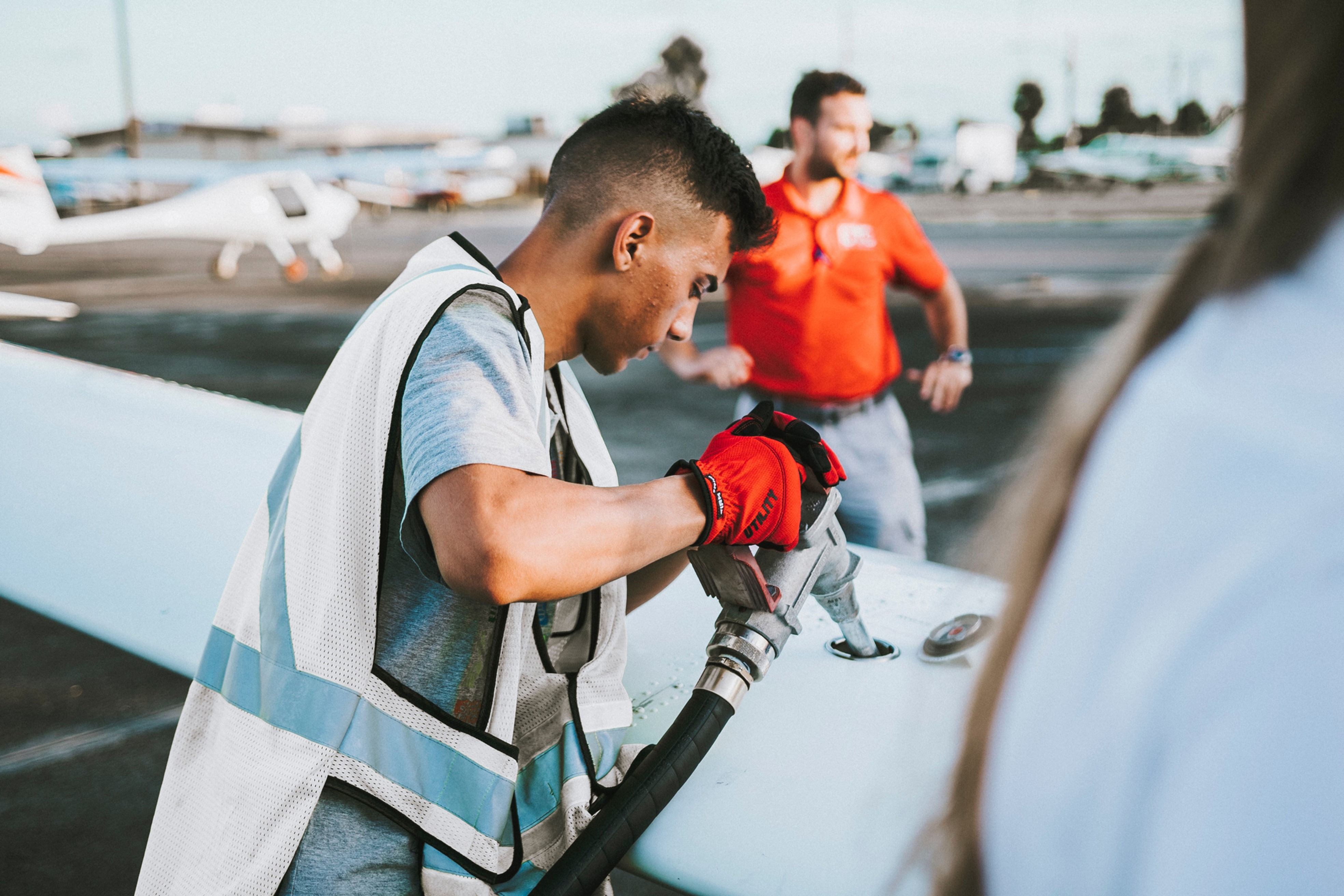 Worker fueling aircraft tank