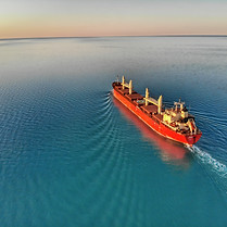 Cargo ship taking fuel at high seas