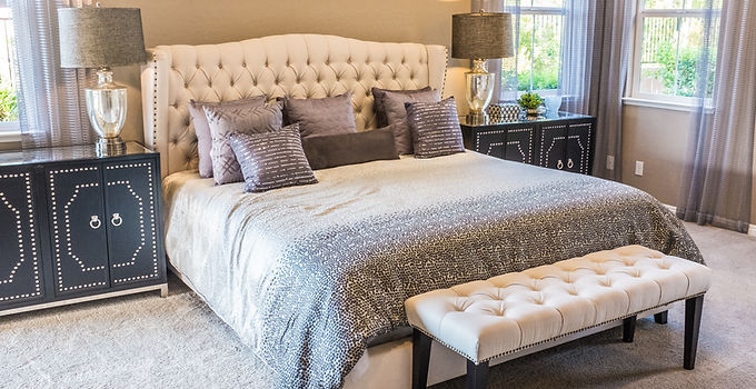 Double bed with an ottoman style headboard and matching stool