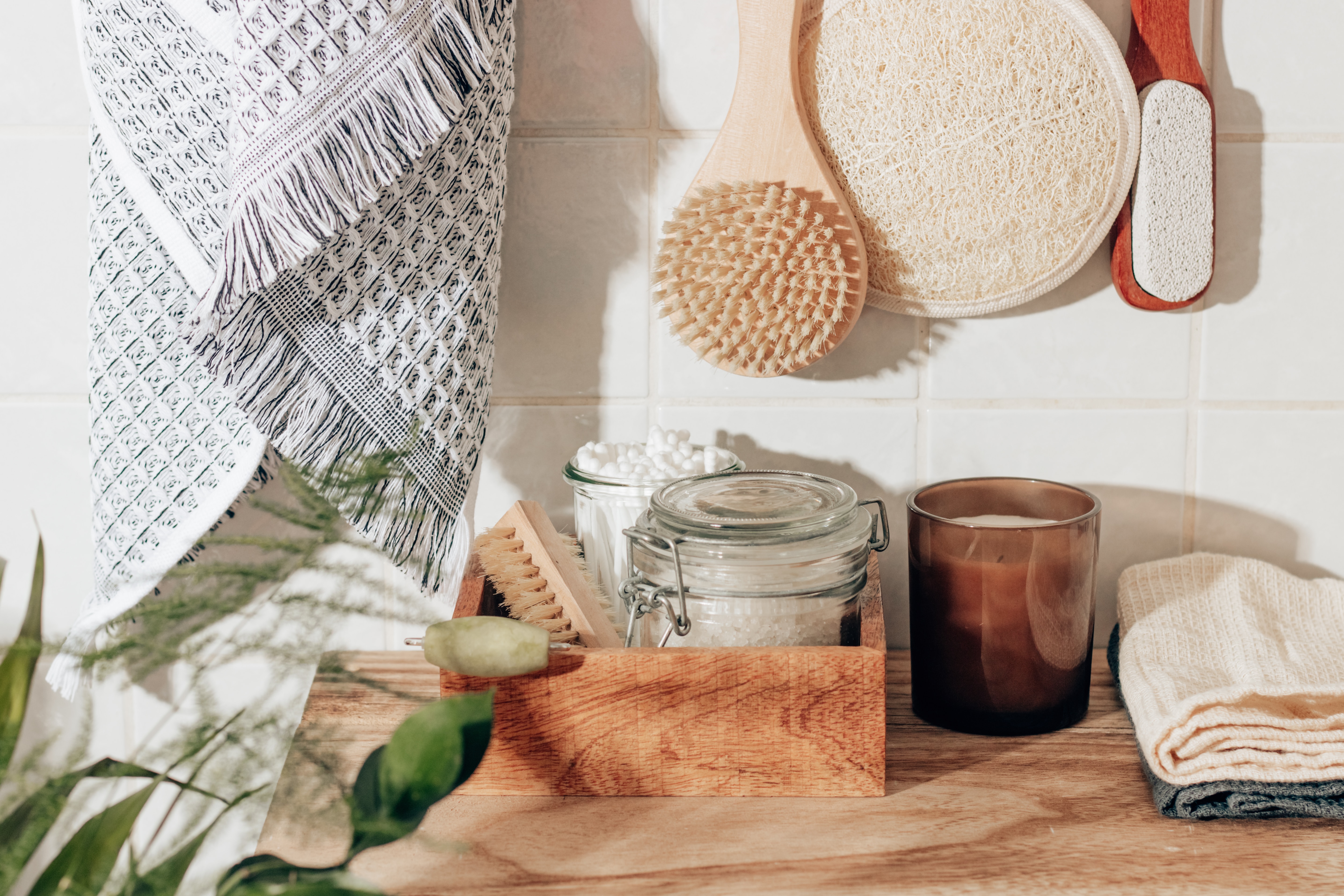 Holistic self-care bath salts, brush, candle and plant