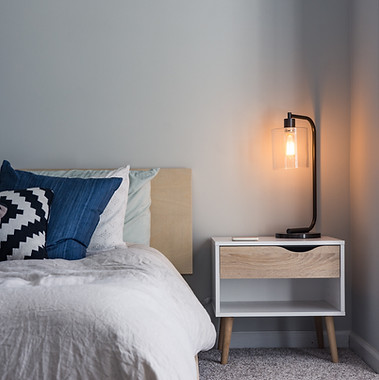 bed with comfy pillows and nightstand